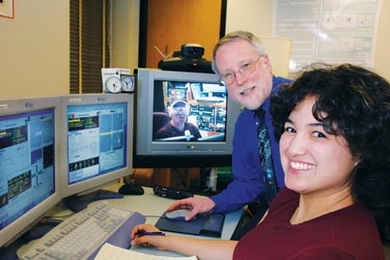 Earth, Atmospheric and Planetary Sciences Professor Richard Binzel, and graduate student Cristina Thomas, are doing remote observing of asteroids using a NASA IRTF telescope in Hawaii that they are controlling from MIT. They are assisted by Paul Sears (on TV screen), a research associate in Hawaii.