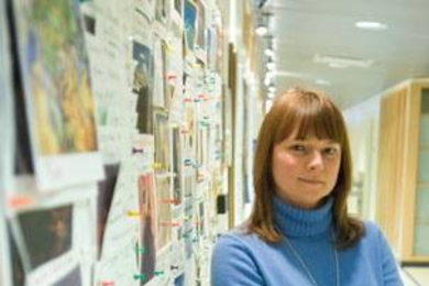 Elizabeth Kubicki, an assistant in the Microsystems Technology Laboratories, stands outside the art contest board near Professor Walter Lewin's office.