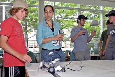 Raquel Velez mentors a student during ROLL's Weekend Robotics Workshop.