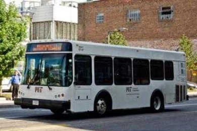 An MIT shuttle bus drives down Vassar Street.