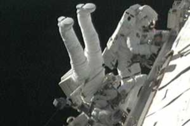 Robert Satcher and Randy Bresnik work outside of the International Space Station during the final spacewalk.