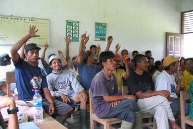 Indonesian village residents participating in a field experiment on direct democracy.