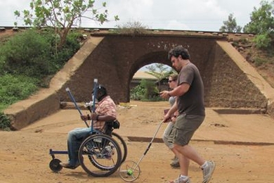 Amos Winter, right, a PhD candidate in mechanical engineering, spent three weeks in January testing the Leveraged Freedom Chair in East Africa.