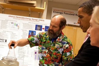 Professor Alex Slocum demonstrates the principle behind anchoring proposed energy-storage tanks to the seafloor, as President Barack Obama and MIT President Susan Hockfield look on.