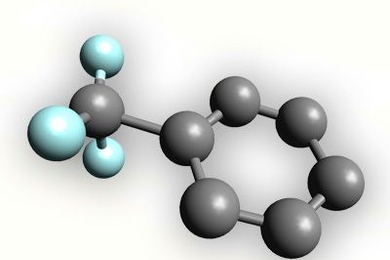 In this model, trifluoromethyl is attached to a ring of six carbons (known as a benzene ring). The gray balls represent carbon atoms, and the blue balls represent fluorine. (Hydrogen atoms attached to the benzene ring are not shown.)