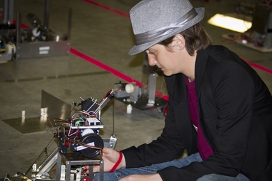 Junior Kelsey Brigance takes a look at one of the two robots she utilized in the competition.