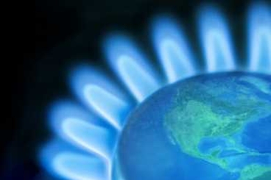 Photo illustration of a stovetop gas burner with an image of the world at the center