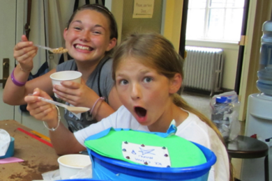 With their ice cream makers that they designed and built in the foreground, these girls enjoy the sweet results of their labors. 