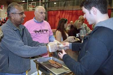 Assistant Director for Finance Hema Fonseka served hot dogs alongside Bob Ferrara, the senior director for strategic planning, communications and alumni relations.