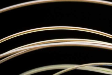 A new fiber developed by Yoel Fink's group emits blue laser light only at a precisely controlled location.