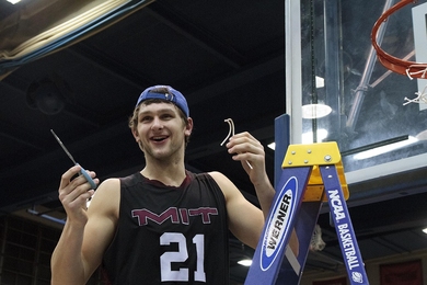 Junior Will Tashman takes his turn cutting down the net after MIT clinched its berth in the NCAA Div. III Final Four. 