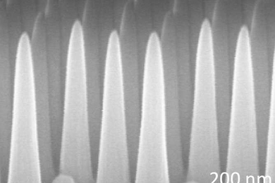 Through a process involving thin layers of material deposited on a surface and then selectively etched away, the MIT team produced a surface covered with tiny cones, each five times taller than their width. This pattern prevents reflections, while at the same time repelling water from the surface.