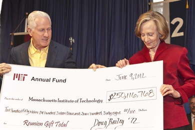Annual Fund Board Chair Doug Bailey '72, SM '74, ME '75 presents a symbolic check to President Susan Hockfield on June 9 for record-breaking reunion giving of $250.1 million.