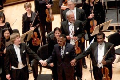 Conductor Arild Remmereit, Composer Olly Wilson and Violist Marcus Thompson bow to a standing ovation.