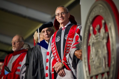 Reif stands on stage next to former MIT Corporation Chairman Dana Mead, center, and Chaplain to the Institute Robert Randolph.