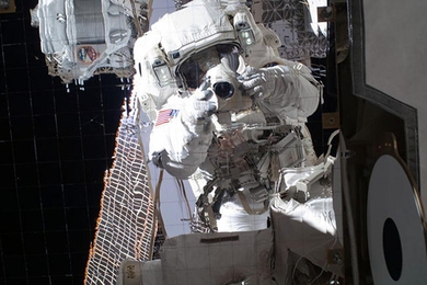 Astronaut Michael Fincke '89 captured this image of his own reflection during a spacewalk. The AMS, already installed on the International Space Station, is just behind him at top left.