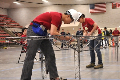 Grant Iwamoto (left) and Maria Tou, co-captain of the MIT Steel Bridge team, constructed the bridge during the regional competition at MIT. 