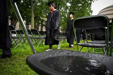 Water puddles up on a seat as graduates make their way into Killian Court.