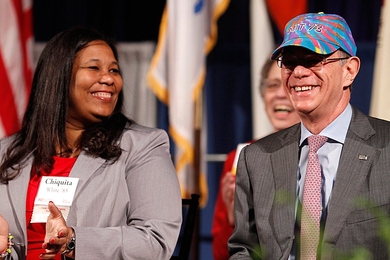 Seated with Alumni Association President Chiquita White '85, MIT President L. Rafael Reif happily accepted a colorful hat symbolizing honorary membership in the Class of 1973, which shares his college graduation year.  