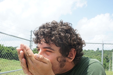 A Mexican member of the team takes the first sip of the purified water produced by the system.