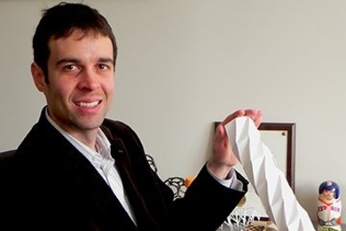 Professor A. John Hart with a folding paper cylinder. Paper's ability to fold and unfold many times and retain its integrity is a motivation for Hart's work on origami-inspired engineering.