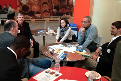 D-Lab associate director Kofi Taha (second from right) speaks with industry representatives and conference participants at a Scaling Development Ventures networking event in February.