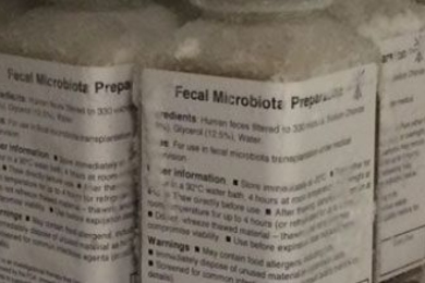5 labeled bottles of fecal microbiota preparate show lists of text.