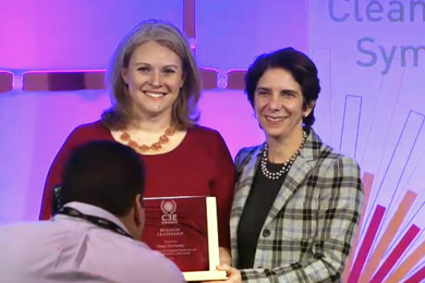 Grace Overlander accepts her award from Lisa Frantzis, senior vice president of strategy and corporate development at Advanced Energy Economy, at the C3E Women in Clean Energy Symposium.