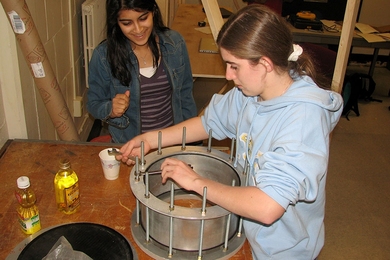 Terrascope students Nikita Consul (left) and Jaclyn Wilson building a pressure vessel to simulate a possible underground facility for sequestering atmospheric carbon dioxide.