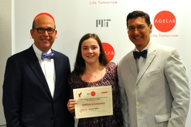 MIT AgeLab's Joe Coughlin (left) and AARP's Michael E. Festa (right) present the inaugural OMEGA award to Lauren Miller.