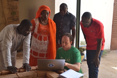 MIT D-Lab researcher Eric Verploegen (seated) kicks off a CITE evaluation of vegetable cooling technologies with partners at the World Vegetable Center.