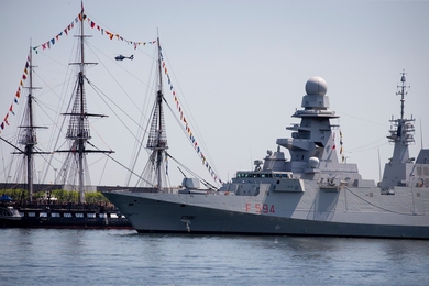 The Italian naval warship ITS Alpino (foreground) sails alongside the USS Constitution in Boston Harbor on June 8, 2018. 