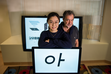 Yena Han (left) and Tomaso Poggio stand with an example of the visual stimuli used in a new psychophysics study.