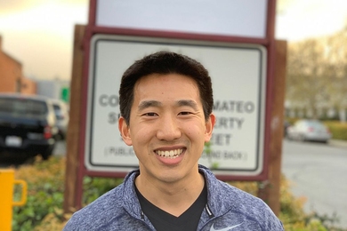 Joel Jean PhD ’17, co-founder of Swift Solar, stands in front of the company’s sign at its permanent location in San Carlos, California.