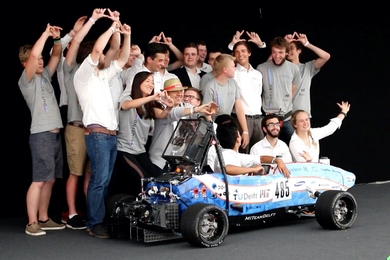 MIT Driverless and TU Delft pose with their race car, DUT18, at Formula Student Germany 2019. The joint team placed third overall.