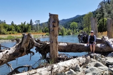 Photo of Isabella Schalko sitting on a logjam