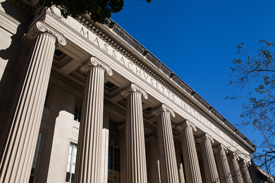 Photo of columns of MIT Building 10, looking up to the sky