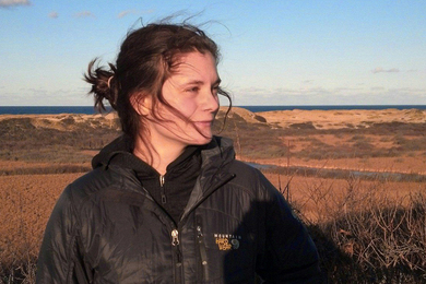 Photo of Caroline White-Nockleby outdoors, with grasslands in the distance