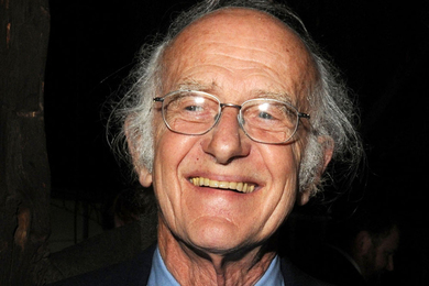 A man with silver hair in a casual headshot photo, smiling and looking to his right