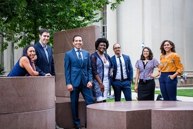 Photo of seven students standing casually outdoors