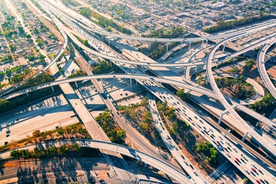 Stock aerial photo of a highway interchange at dusk