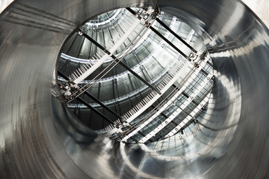The interior of the KATRIN main spectrometer, a shiny silver, mainly spherical structure, with the field shaping wire electrodes in view.
