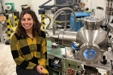 Portrait of Zoe Fisher in the lab, seated and smiling