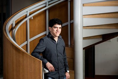 Armando Solar-Lezama stands at the bottom of a circular stairwell for a photo.