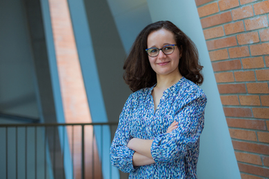 Isabel Naranjo De Candido standing with arms folded, indoors 