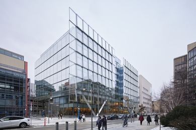 Photo of the facade of the MIT Schwarzman College of Computing building, which features a shingled glass exterior that reflects its surroundings
