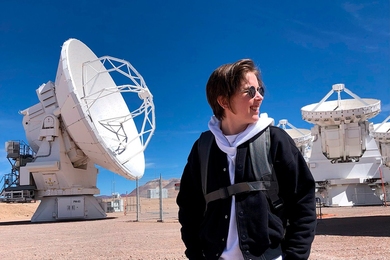 Jess Speedie stands outside with one of the ALMA dishes behind her.