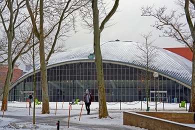 A photo of Kresge Auditorium covered in snow with students walking in winter jackets.