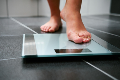 Feet stepping on a scale