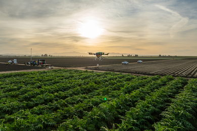 A large drone delivering supplies to a farm